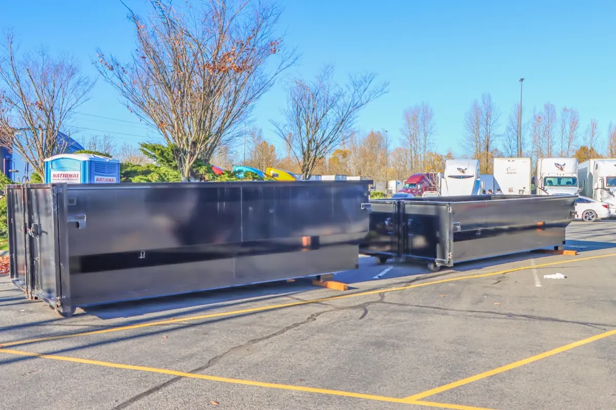 Professional dumpster rental service with roll-off container on residential driveway in White Bear Lake